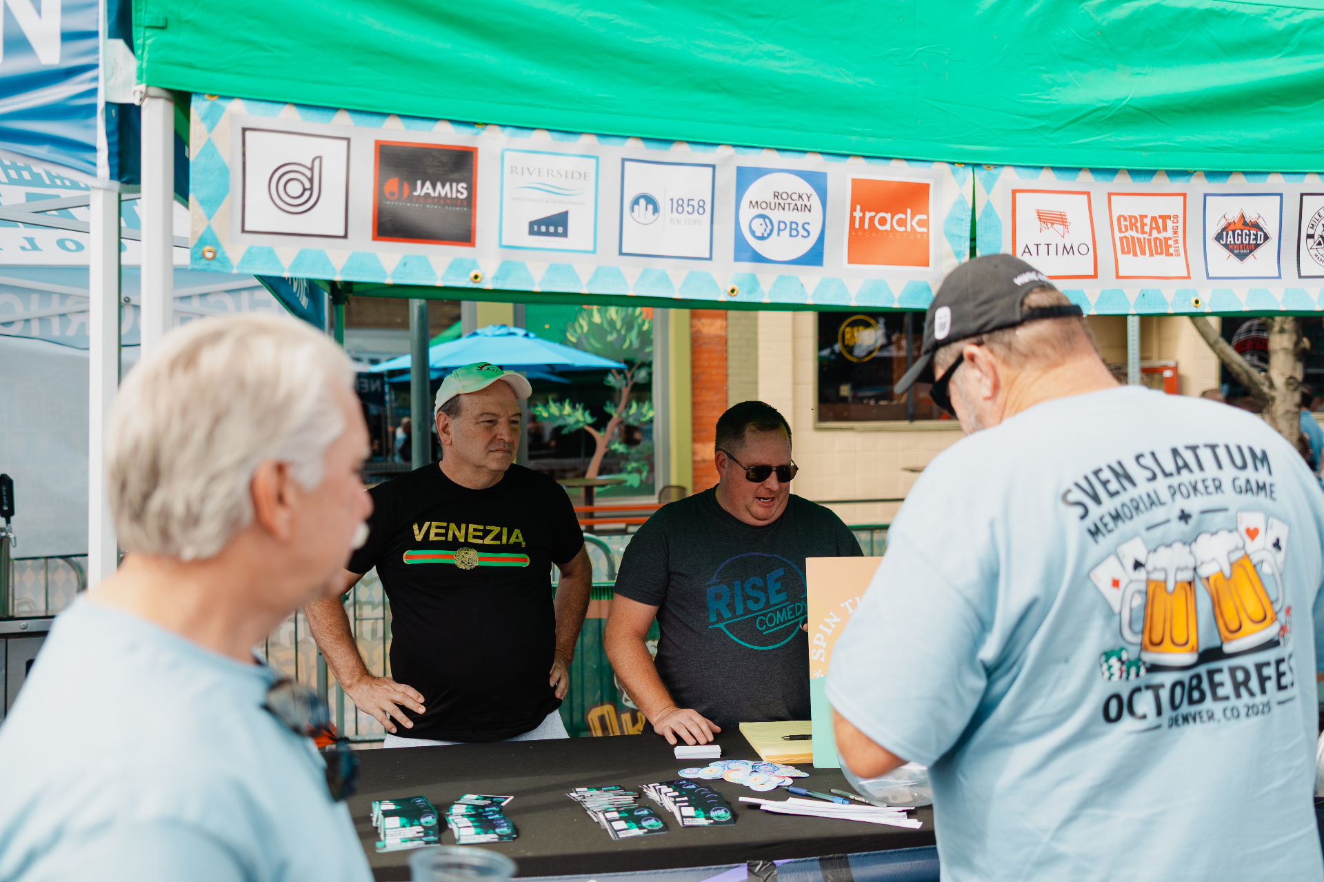 Sponsors and volunteers hanging out at the Ballpark District festival booth