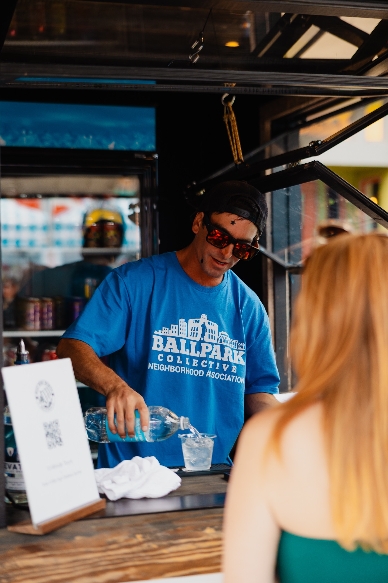 Ballpark Collective volunteer pouring a drink at the festival